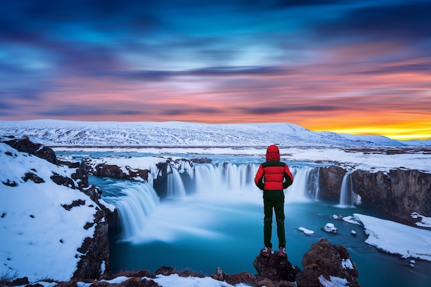 https://img.freepik.com/free photo/godafoss waterfall sunset winter iceland guy red jacket looks godafoss waterfall 335224 673.jpg